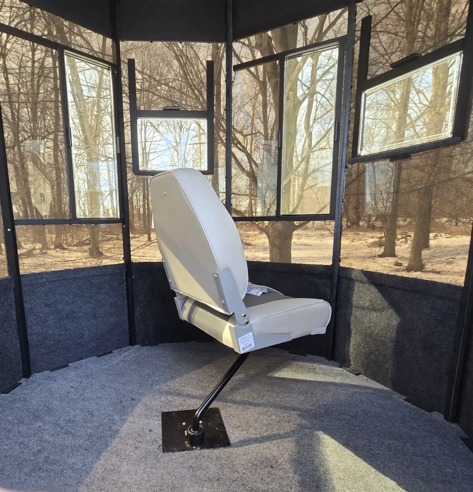 Buckeye blind hunting seat inside a Lifetime Manufacturing blind where you can see out through the walls of the blind